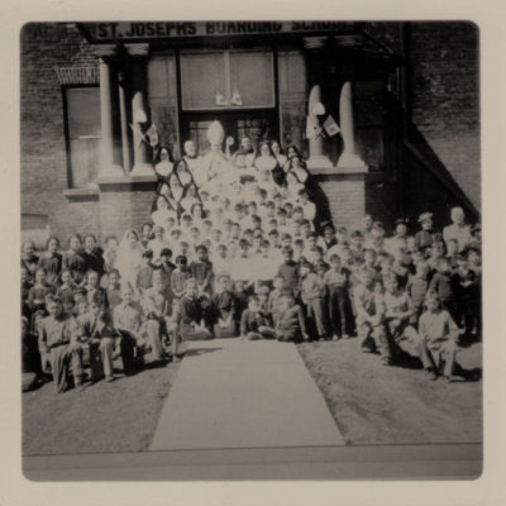 A photograph of a young Morrisseau and his classmates in front of their Indian residential school