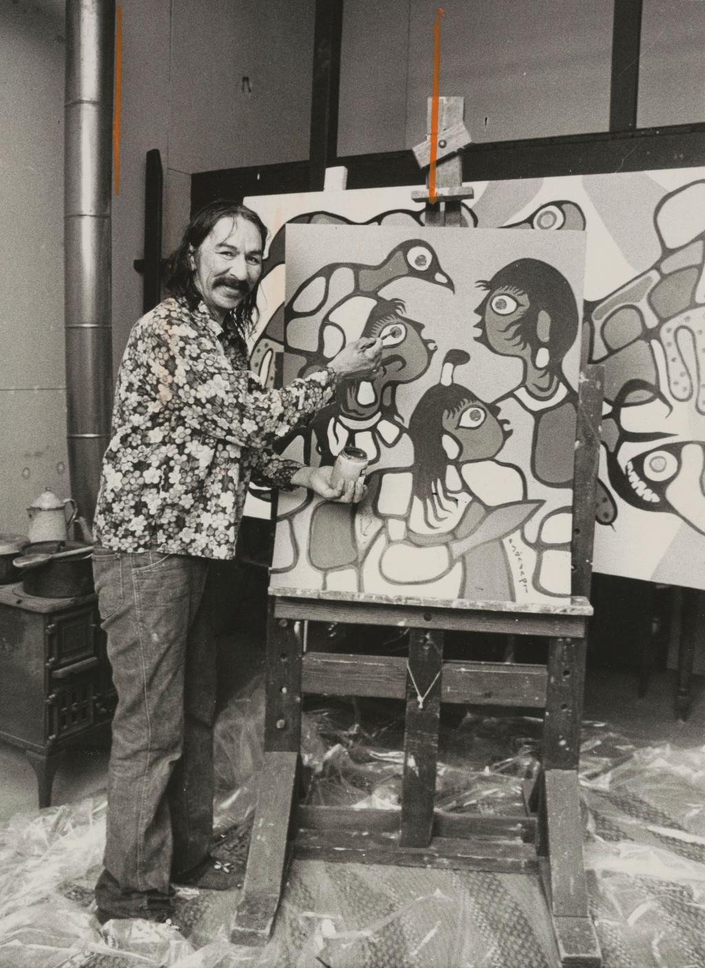 Photograph of Morrisseau in front of a painting
